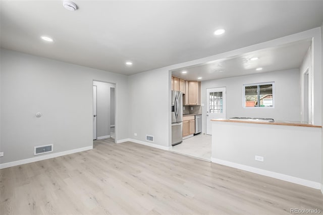 unfurnished living room with light wood-style flooring, visible vents, and recessed lighting