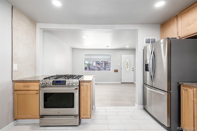 kitchen with appliances with stainless steel finishes, baseboards, and recessed lighting