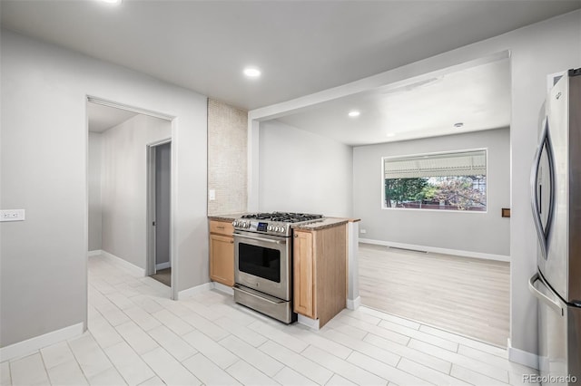 kitchen featuring visible vents, baseboards, appliances with stainless steel finishes, recessed lighting, and light stone countertops