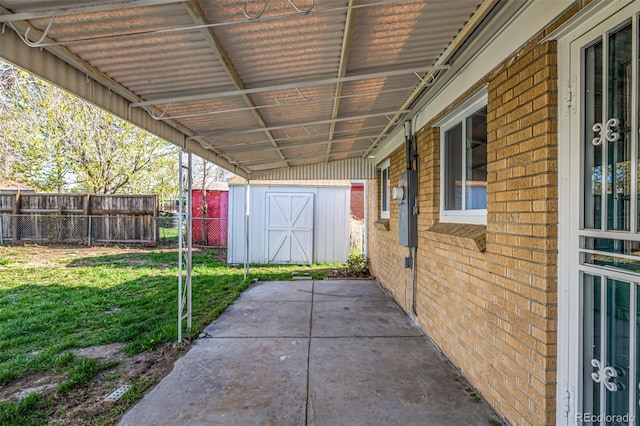 view of patio featuring fence, an outbuilding, and a storage unit