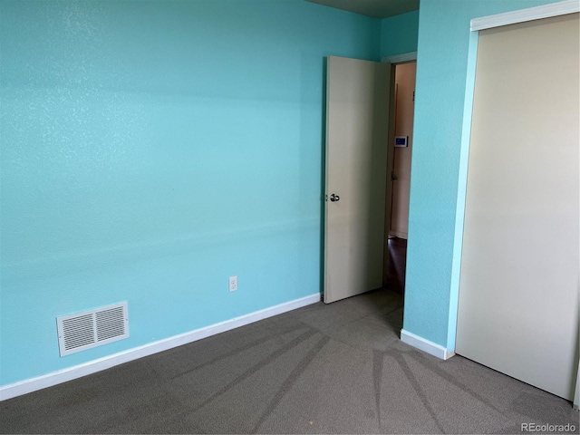 unfurnished bedroom featuring carpet floors and a closet