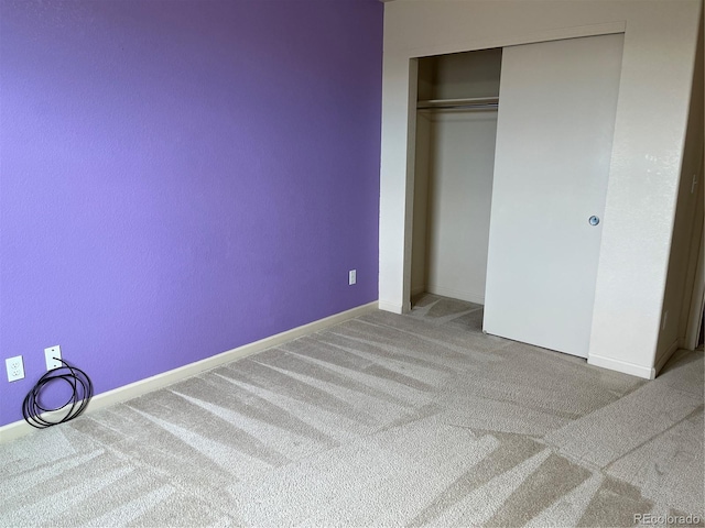 unfurnished bedroom featuring carpet floors and a closet