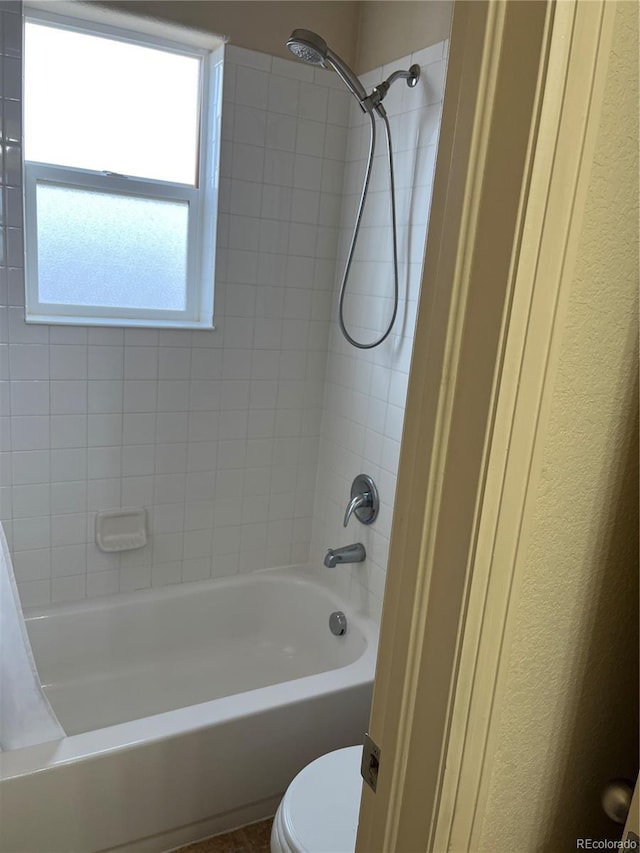 bathroom featuring toilet and shower / bathtub combination with curtain