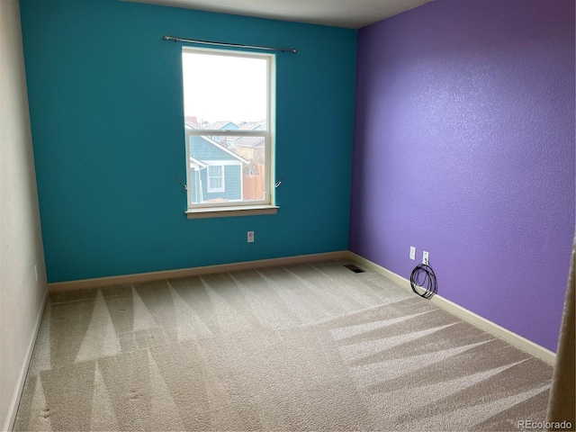 unfurnished room featuring carpet