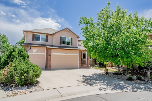 17672 E Weaver Pl, Aurora, CO 80016 - view of front of property with a garage, brick siding, and concrete driveway