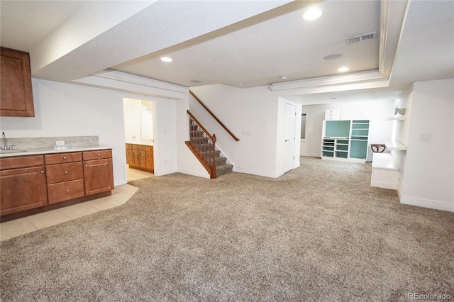 17672 E Weaver Pl, Aurora, CO 80016 - unfurnished living room with light carpet, stairs, a tray ceiling, and recessed lighting