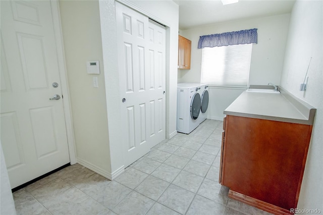 17672 E Weaver Pl, Aurora, CO 80016 - laundry area featuring cabinet space, washing machine and clothes dryer, and light tile patterned floors