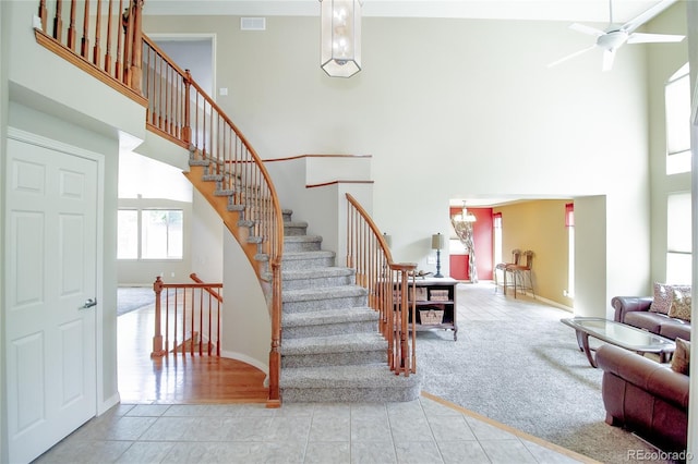17672 E Weaver Pl, Aurora, CO 80016 - staircase with a high ceiling, a ceiling fan, and carpet flooring