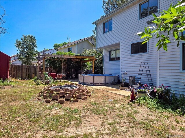20391 E 42nd Ave, Denver, CO 80249 - view of yard with an outdoor pool and a pergola