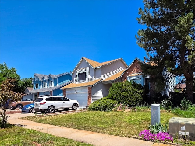 20391 E 42nd Ave, Denver, CO 80249 - view of front of home featuring an attached garage, a front yard, concrete driveway, and brick siding