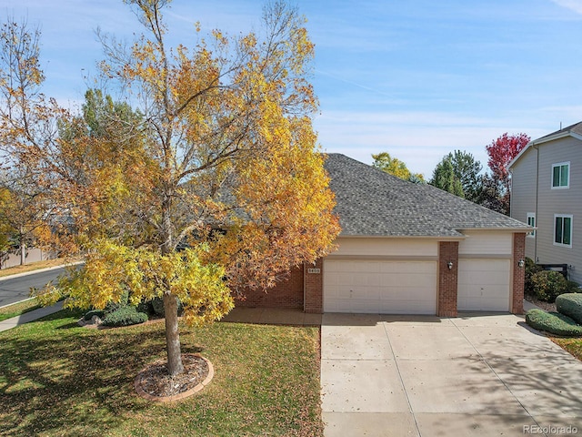 view of front of property with a front lawn and a garage