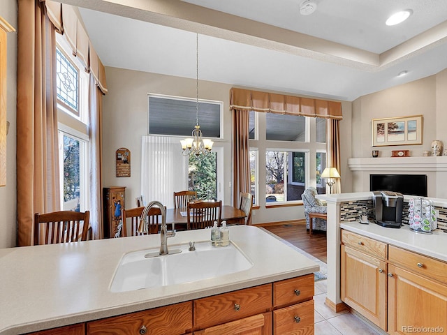 kitchen with a chandelier, decorative light fixtures, plenty of natural light, and sink