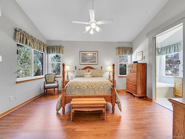 bedroom with hardwood / wood-style floors, vaulted ceiling, multiple windows, and ceiling fan