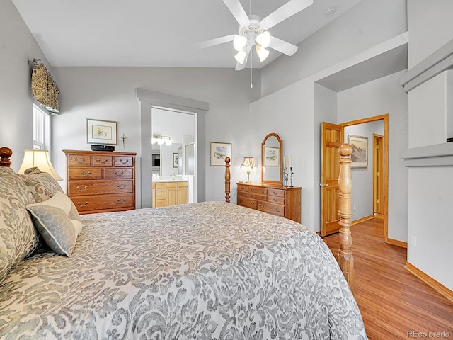 bedroom with connected bathroom, ceiling fan, light hardwood / wood-style floors, and vaulted ceiling