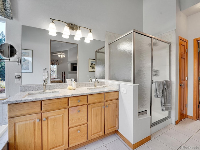 bathroom with tile patterned floors, ceiling fan, a healthy amount of sunlight, and a shower with door