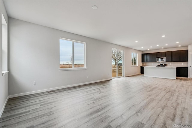 unfurnished living room featuring light wood-type flooring