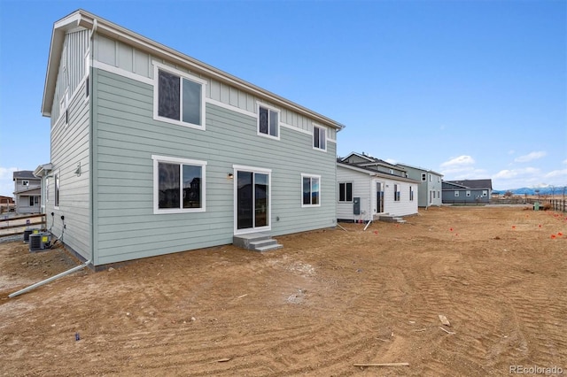 rear view of house with central AC unit