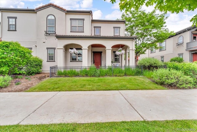 3372 Central Park Blvd, Denver, CO 80238 - mediterranean / spanish house featuring covered porch and stucco siding