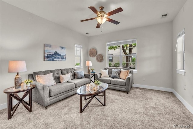 3372 Central Park Blvd, Denver, CO 80238 - living room with baseboards, a ceiling fan, and light colored carpet