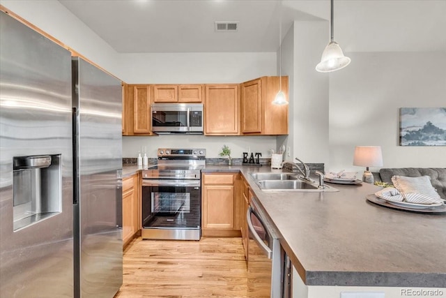 3372 Central Park Blvd, Denver, CO 80238 - kitchen featuring stainless steel appliances, a sink, a peninsula, light wood-style floors, and hanging light fixtures