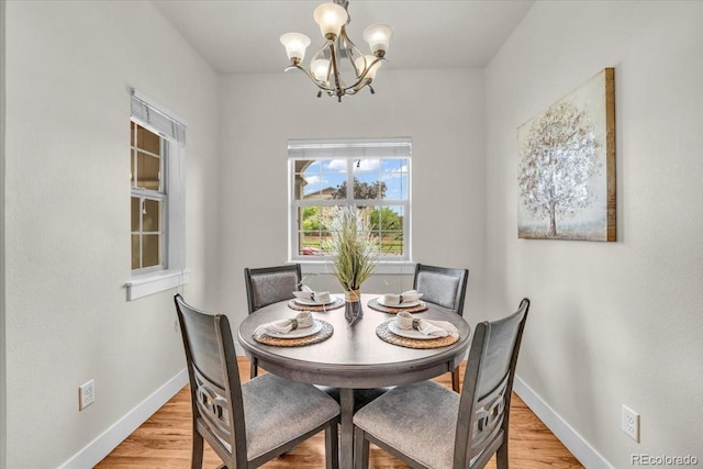 3372 Central Park Blvd, Denver, CO 80238 - dining space featuring a chandelier, baseboards, and light wood-type flooring