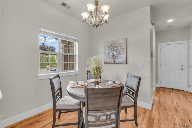 3372 Central Park Blvd, Denver, CO 80238 - dining space with baseboards, light wood-style floors, and a chandelier
