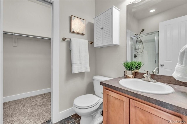 3372 Central Park Blvd, Denver, CO 80238 - bathroom featuring a shower stall, vanity, toilet, a spacious closet, and baseboards