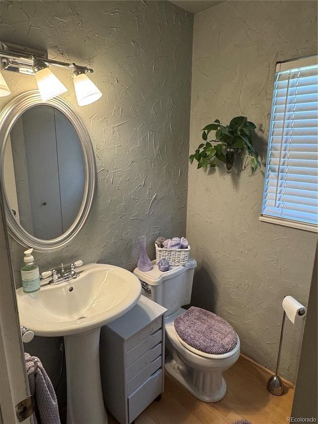 12534 E Pacific Cir Unit A, Aurora, CO 80014 - half bath featuring wood finished floors and toilet