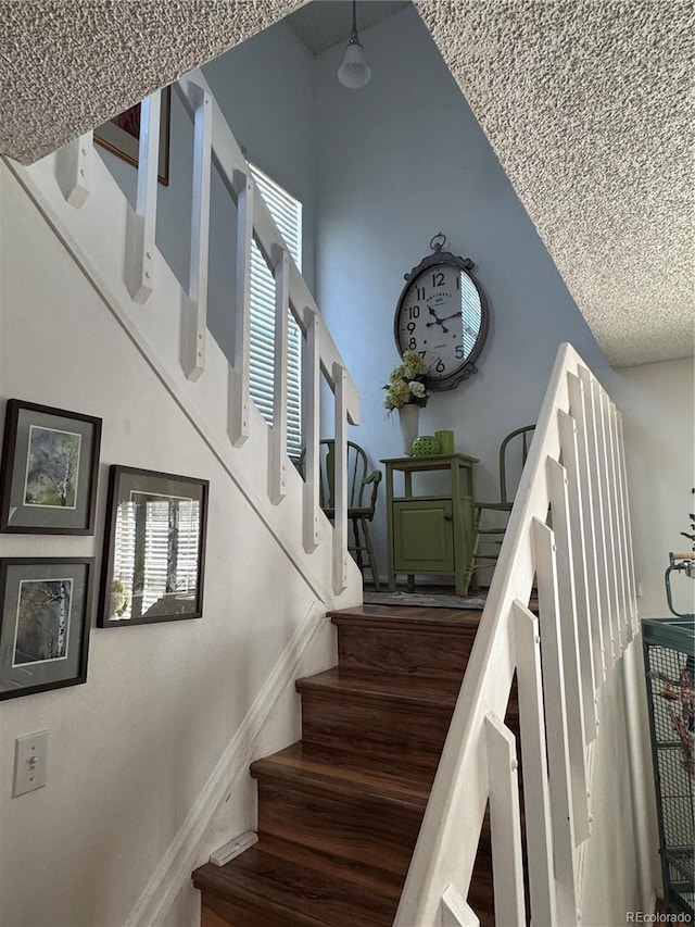 12534 E Pacific Cir Unit A, Aurora, CO 80014 - stairway with a textured ceiling
