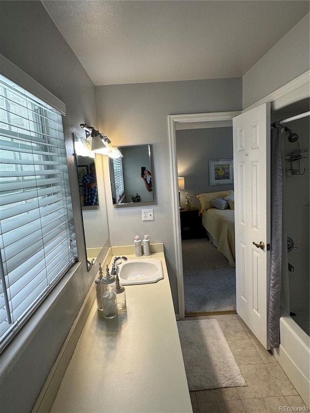 12534 E Pacific Cir Unit A, Aurora, CO 80014 - full bath with vanity, shower / bath combo with shower curtain, connected bathroom, and tile patterned floors