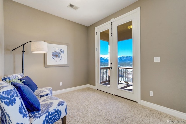 living area featuring french doors, carpet, visible vents, and baseboards