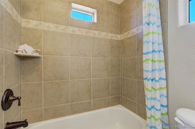 bathroom featuring toilet and shower / tub combo with curtain