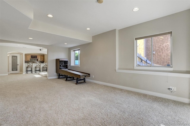 interior space with light carpet, recessed lighting, and baseboards