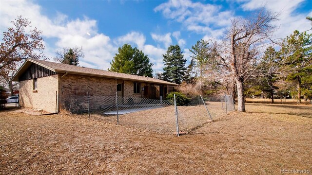 exterior space featuring brick siding and fence