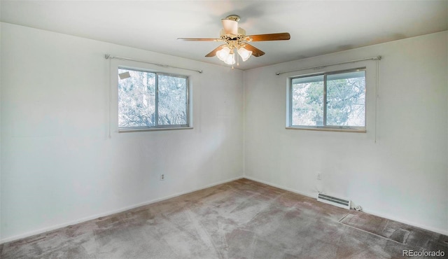 carpeted empty room featuring visible vents, plenty of natural light, and a ceiling fan