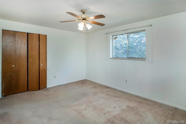 unfurnished bedroom with carpet flooring, a closet, and ceiling fan