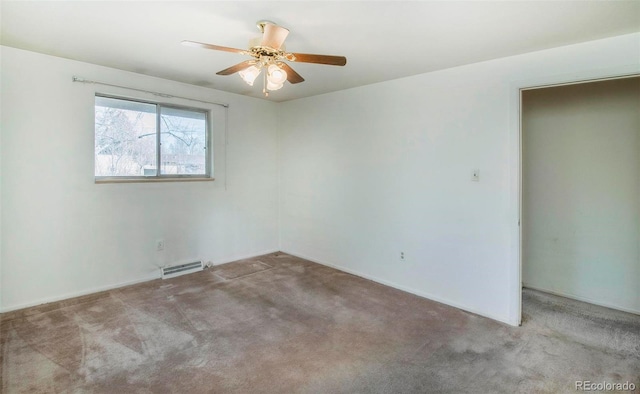 carpeted empty room with visible vents and a ceiling fan