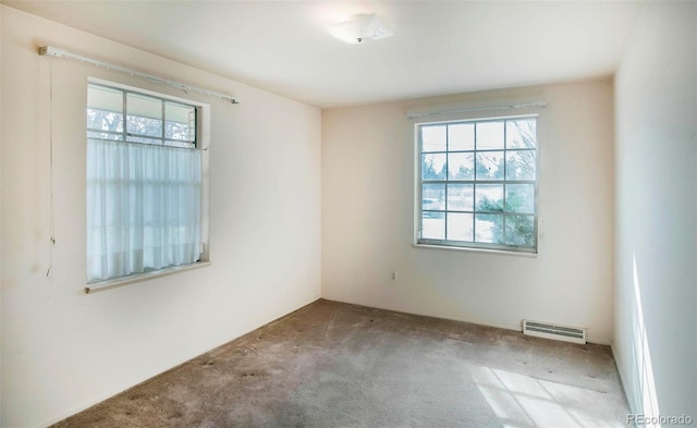 unfurnished room with visible vents and carpet floors