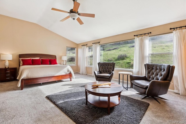 bedroom featuring lofted ceiling, multiple windows, ceiling fan, and carpet