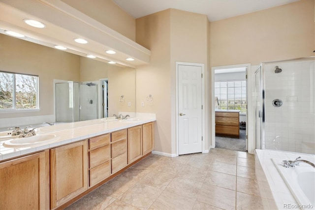 full bathroom with a stall shower, a sink, and plenty of natural light