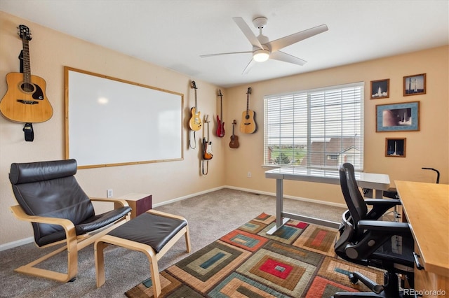 carpeted office featuring a ceiling fan and baseboards