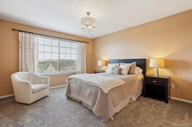 carpeted bedroom featuring baseboards and a notable chandelier
