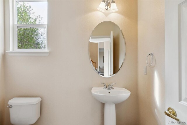 half bathroom featuring a sink and toilet