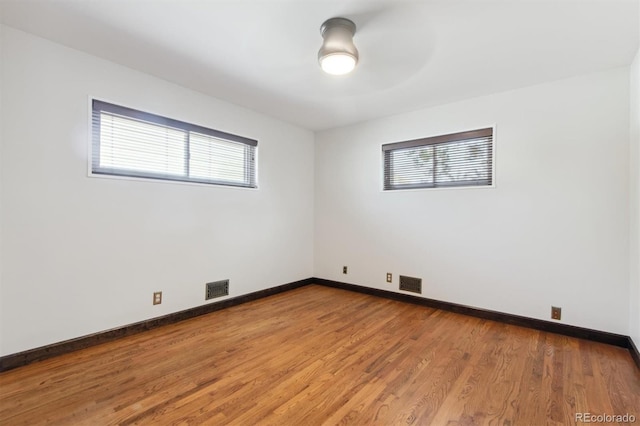 spare room featuring hardwood / wood-style flooring