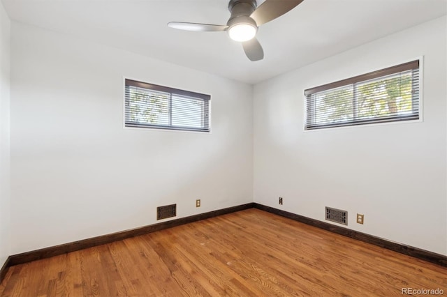 spare room featuring hardwood / wood-style flooring and ceiling fan