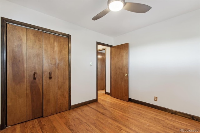 unfurnished bedroom with ceiling fan, light hardwood / wood-style floors, and a closet