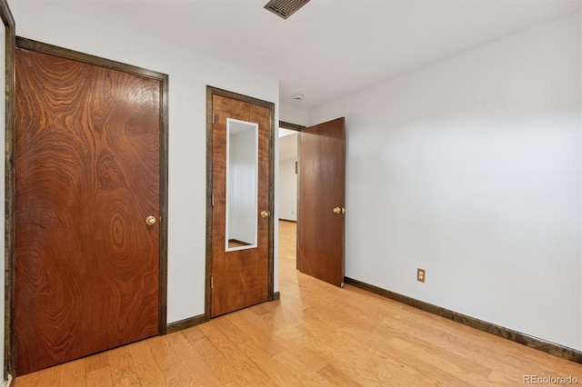 unfurnished bedroom featuring light wood-type flooring