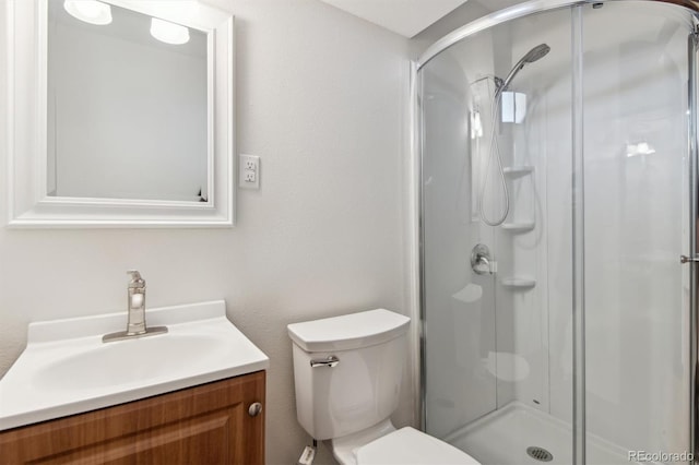 bathroom with walk in shower, vanity, and toilet