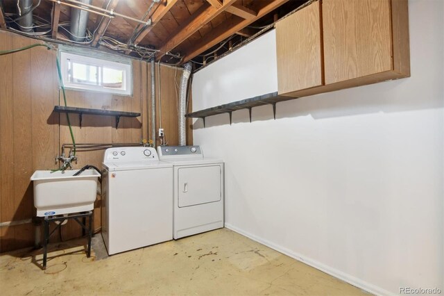 washroom featuring cabinets, sink, and washer and dryer