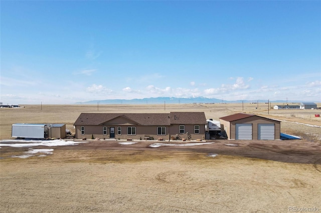 exterior space with a garage and a mountain view